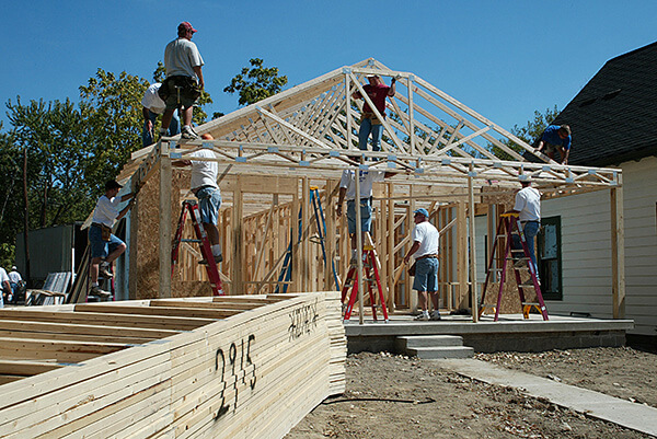 People building house frame